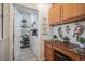 Laundry room with built-in desk and shelving at 7865 Vallagio Ln # 308, Englewood, CO 80112