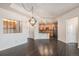 Open concept living room with wood floors with an ornamental divider to the kitchen at 7865 Vallagio Ln # 308, Englewood, CO 80112
