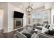 Cozy living room featuring a fireplace, large windows, and comfortable seating at 7865 Vallagio Ln # 308, Englewood, CO 80112