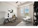 Home office featuring a tray ceiling, carpet, and natural light from the large windows at 7865 Vallagio Ln # 308, Englewood, CO 80112