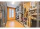 Secured storage room with metal mesh enclosures and an orange wall with a small window at 7865 Vallagio Ln # 308, Englewood, CO 80112