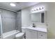Bathroom features a tiled shower, white vanity and a bright overhead light at 10878 Patterson Ct, Northglenn, CO 80234
