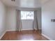 Bedroom with hardwood floors, neutral walls, and a bright window view at 10878 Patterson Ct, Northglenn, CO 80234
