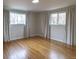 Spacious bedroom featuring hardwood floors, light walls and neutral curtains at 10878 Patterson Ct, Northglenn, CO 80234