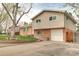 Split-level home featuring a brick and siding exterior, showcasing an attached garage and inviting curb appeal at 10878 Patterson Ct, Northglenn, CO 80234