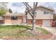 Charming brick and siding home with a well-maintained lawn and a welcoming front entrance at 10878 Patterson Ct, Northglenn, CO 80234
