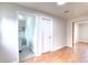 Open hallway featuring hardwood floors with access to laundry and a room at 10878 Patterson Ct, Northglenn, CO 80234