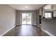Comfortable living room with hardwood flooring, large windows, and a view of the fireplace at 10878 Patterson Ct, Northglenn, CO 80234