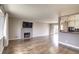 Spacious living room with hardwood floors, a fireplace, and an open layout connecting to the kitchen at 10878 Patterson Ct, Northglenn, CO 80234
