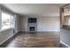 Bright living room with hardwood floors, large windows, and a cozy fireplace, perfect for relaxation at 10878 Patterson Ct, Northglenn, CO 80234