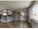 Open-concept living space featuring hardwood floors, natural light, and a seamless flow to the kitchen at 10878 Patterson Ct, Northglenn, CO 80234