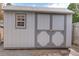 Image of a well maintained backyard shed with painted double doors and a small window at 10878 Patterson Ct, Northglenn, CO 80234