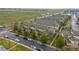 Aerial view of townhomes with a well-manicured lawn and surrounding trees at 5800 Tower Rd # 610, Denver, CO 80249