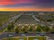 An aerial view of new townhomes displaying professional landscaping at sunset at 5800 Tower Rd # 610, Denver, CO 80249