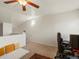 Bedroom with neutral carpet, ceiling fan, and adjacent staircase at 5800 Tower Rd # 610, Denver, CO 80249