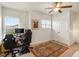Bedroom featuring carpet, large window, ceiling fan, and closet space at 5800 Tower Rd # 610, Denver, CO 80249