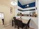 Cozy dining area with a table set for four, adjacent to the kitchen with a stylish accent wall at 5800 Tower Rd # 610, Denver, CO 80249