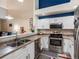 Well-lit kitchen with a view to the living area, showcasing modern appliances and ample counter space at 5800 Tower Rd # 610, Denver, CO 80249