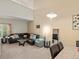 Bright living room with vaulted ceilings, a comfortable sectional, and stylish decor at 5800 Tower Rd # 610, Denver, CO 80249
