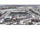 Aerial view of a shopping center and residential area covered in snow at 9624 Martin Luther King Blvd, Denver, CO 80238