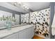 Bathroom with marble countertop, shower, and modern fixtures at 9624 Martin Luther King Blvd, Denver, CO 80238