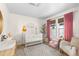 Charming Bedroom with crib, rocker, and plenty of natural light at 9624 Martin Luther King Blvd, Denver, CO 80238