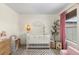 Bright Bedroom featuring a crib, chair, and plenty of natural light at 9624 Martin Luther King Blvd, Denver, CO 80238