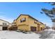 View of multiple townhouses with snow-covered driveways at 9624 Martin Luther King Blvd, Denver, CO 80238