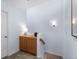 A light-filled hallway with built-in cabinets and stairs at 9624 Martin Luther King Blvd, Denver, CO 80238