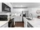 Well-equipped kitchen featuring white cabinets and modern appliances at 9624 Martin Luther King Blvd, Denver, CO 80238