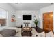 Bright living room with hardwood floors, comfy seating, and a large TV at 9624 Martin Luther King Blvd, Denver, CO 80238