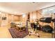 Basement area with wood paneling, a comfortable couch, a vintage rug, and an exercise bike at 1462 S Dudley St, Lakewood, CO 80232
