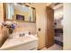 Bathroom with large sink, mirror, neutral color palette and access to the Dining room at 1462 S Dudley St, Lakewood, CO 80232