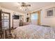 Bedroom featuring double closets, dresser, TV, glass-topped end table, and large patterned area rug at 1462 S Dudley St, Lakewood, CO 80232