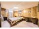 Charming bedroom featuring wood-paneled walls, a cozy bed, and a functional desk area at 1462 S Dudley St, Lakewood, CO 80232