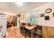 Cozy dining area adjacent to the kitchen with natural light and hardwood floors at 1462 S Dudley St, Lakewood, CO 80232