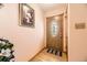 Warm and inviting foyer with hardwood floors and decorative front door at 1462 S Dudley St, Lakewood, CO 80232