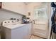 Laundry room featuring washer, dryer, storage and access to the backyard at 1462 S Dudley St, Lakewood, CO 80232