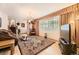 Bright living room features a large window, chandelier, and hardwood floors at 1462 S Dudley St, Lakewood, CO 80232