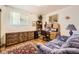 Office space with wood floors, area rug, desk, chair, shelves, cabinets and a comfortable-looking sofa at 1462 S Dudley St, Lakewood, CO 80232
