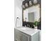 Stylish bathroom with marble countertop, gold fixtures, and elegant mirror at 1248 Ursula St, Aurora, CO 80011