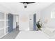 Bright primary bedroom with en-suite bathroom access, ceiling fan, and gray carpeting at 1248 Ursula St, Aurora, CO 80011