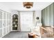 Bright Bedroom with white walls, a crib, comfortable chair, and modern light fixture at 1248 Ursula St, Aurora, CO 80011