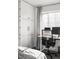 Bedroom featuring built-in storage, a home office area, and bright natural light at 1248 Ursula St, Aurora, CO 80011