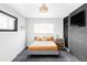 Charming bedroom featuring an accent wall and a comfortable bed with bright, welcoming decor at 1248 Ursula St, Aurora, CO 80011
