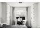 Bright bedroom with built-in storage, home office area, and a large window at 1248 Ursula St, Aurora, CO 80011