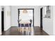 Dining room with hardwood floors, blue chairs around wood table and modern wicker pendant lighting at 1248 Ursula St, Aurora, CO 80011