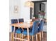Well-appointed dining room featuring a wooden table with blue upholstered chairs and stylish lighting at 1248 Ursula St, Aurora, CO 80011