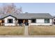 Beautiful one-story home featuring a well-kept lawn and cozy front porch seating at 1248 Ursula St, Aurora, CO 80011