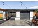 Detached garage with updated lighting and adjacent screened-in porch at 1248 Ursula St, Aurora, CO 80011